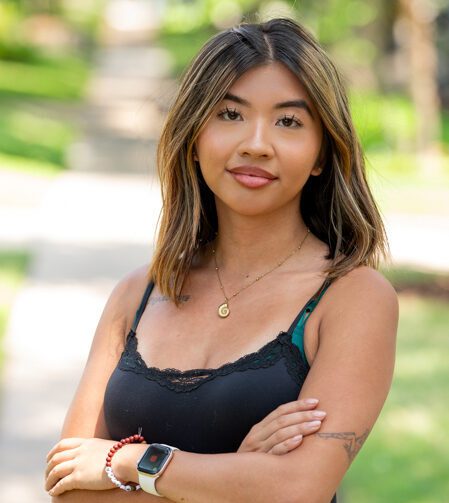 Alisa Nong – SEO Impact Pros Alisa Nong, Senior Content Marketing Manager, standing with arms crossed outdoors